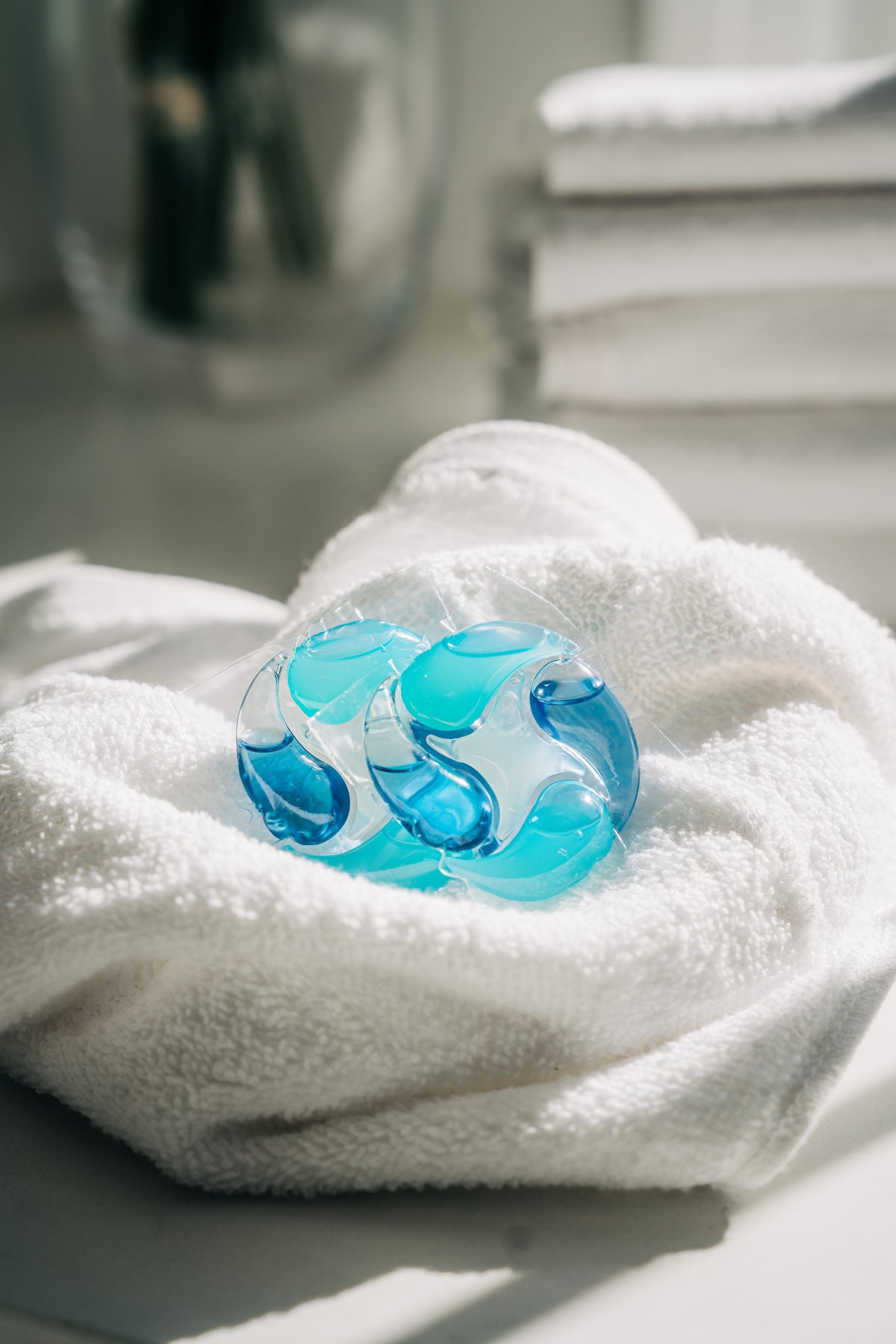 Blue glass marble on a white towel with a blurred background