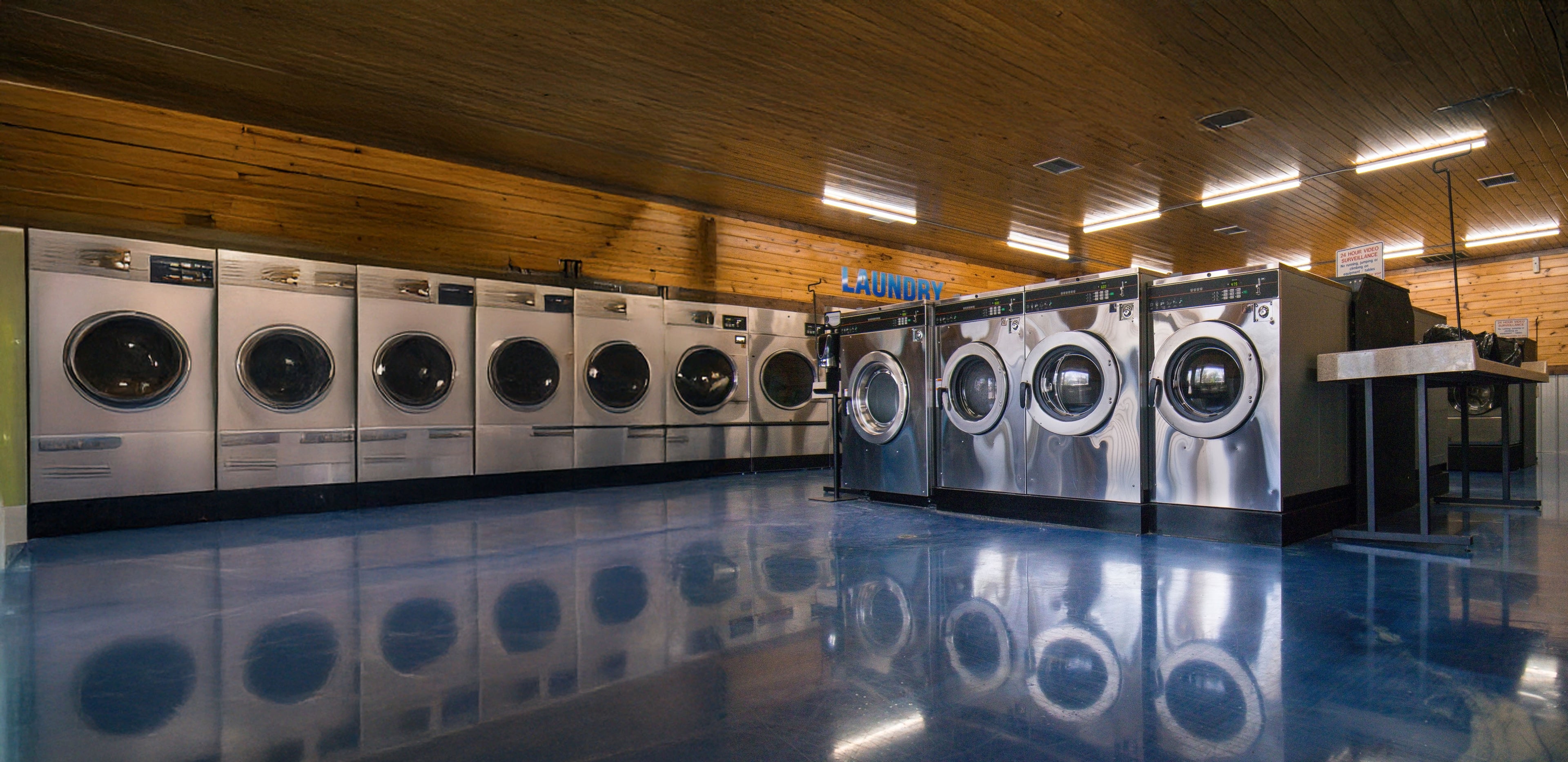 Row of commercial washing machines in a laundromat