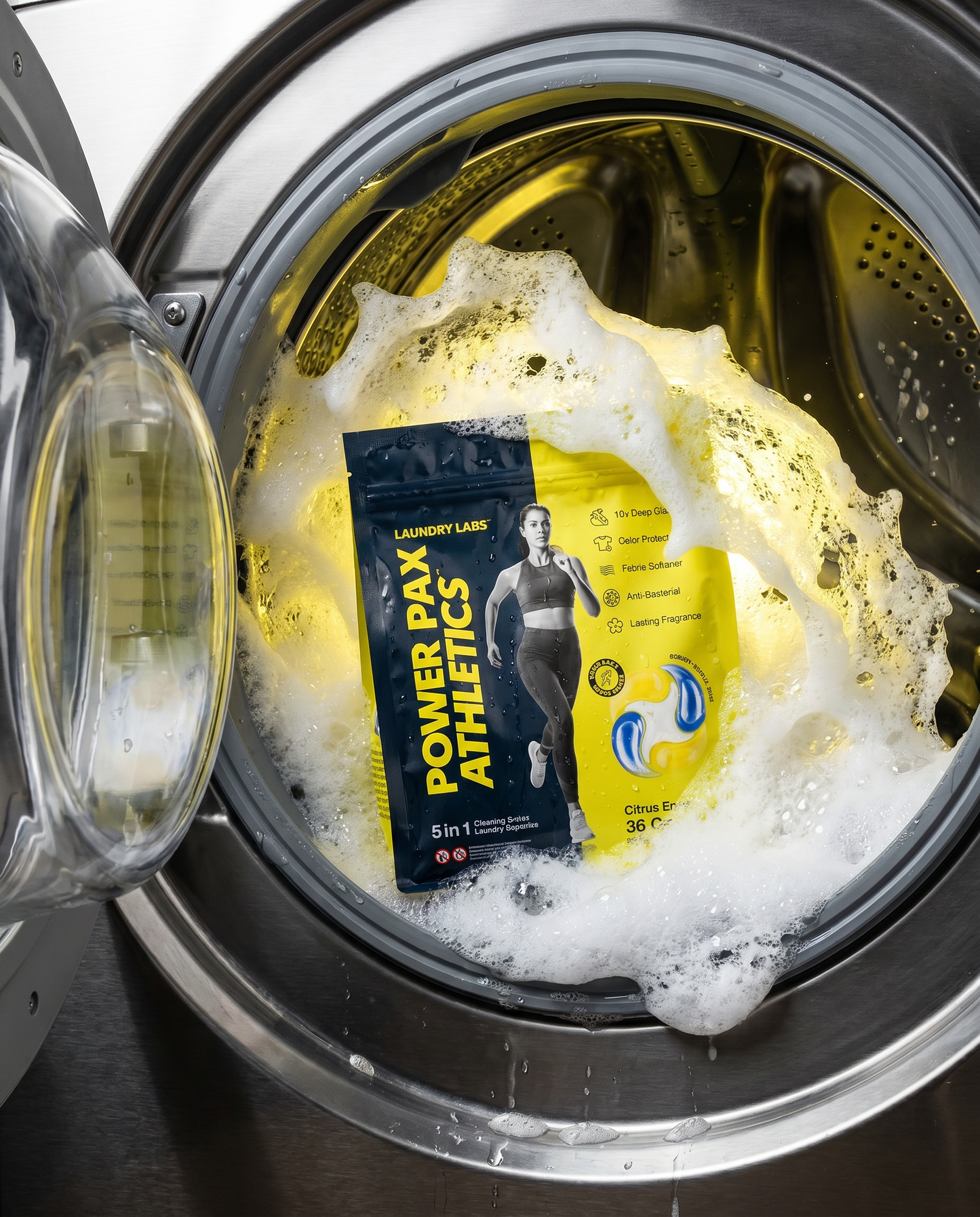 Power Pax Athletics laundry detergent packet in a washing machine with soap suds.