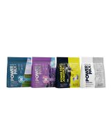 Four Power Play sports drink pouches lined up horizontally on a plain white background. The pouches are in different colorways: blue, purple, black and yellow, and white.