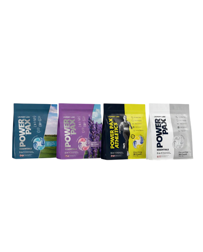 Four Power Play sports drink pouches lined up horizontally on a plain white background. The pouches are in different colorways: blue, purple, black and yellow, and white.